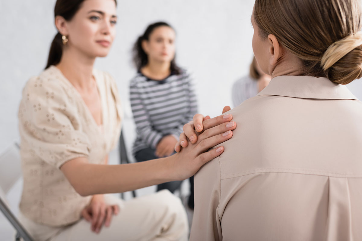 woman comforting other woman